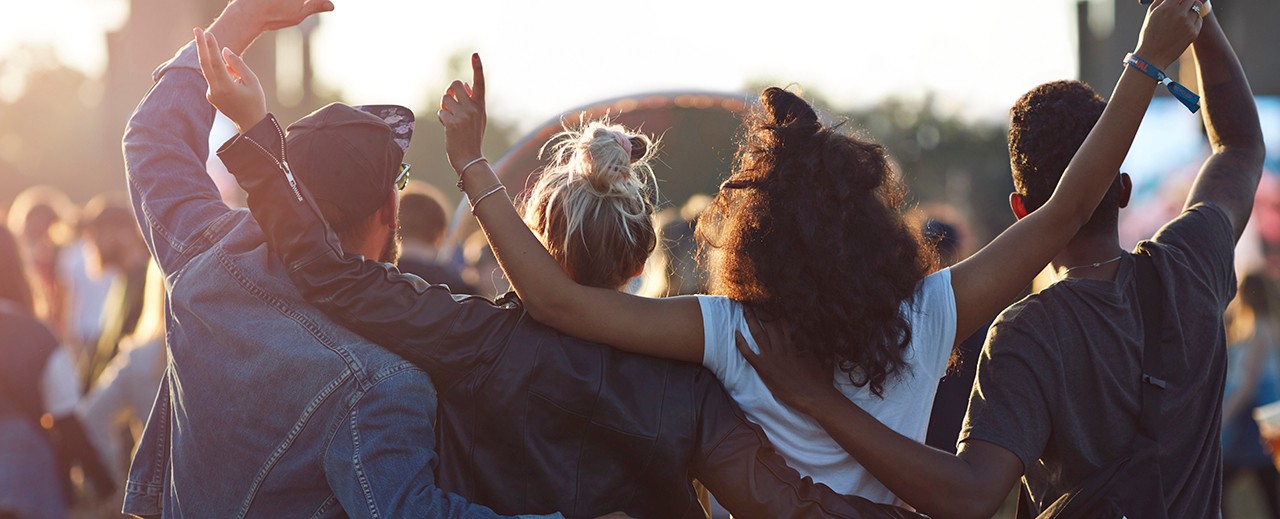 4 people celebrating in a public event