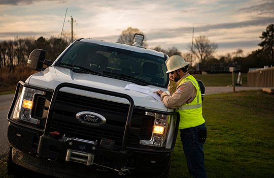 line worker standing by fleet truck