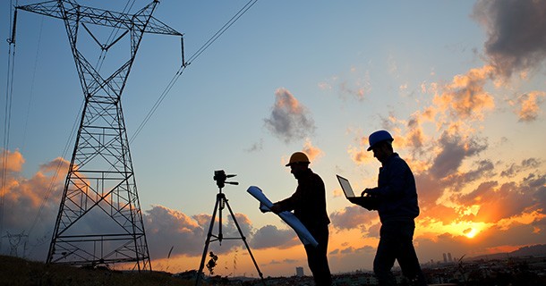 Silhouette of engineers workers at electricity station.