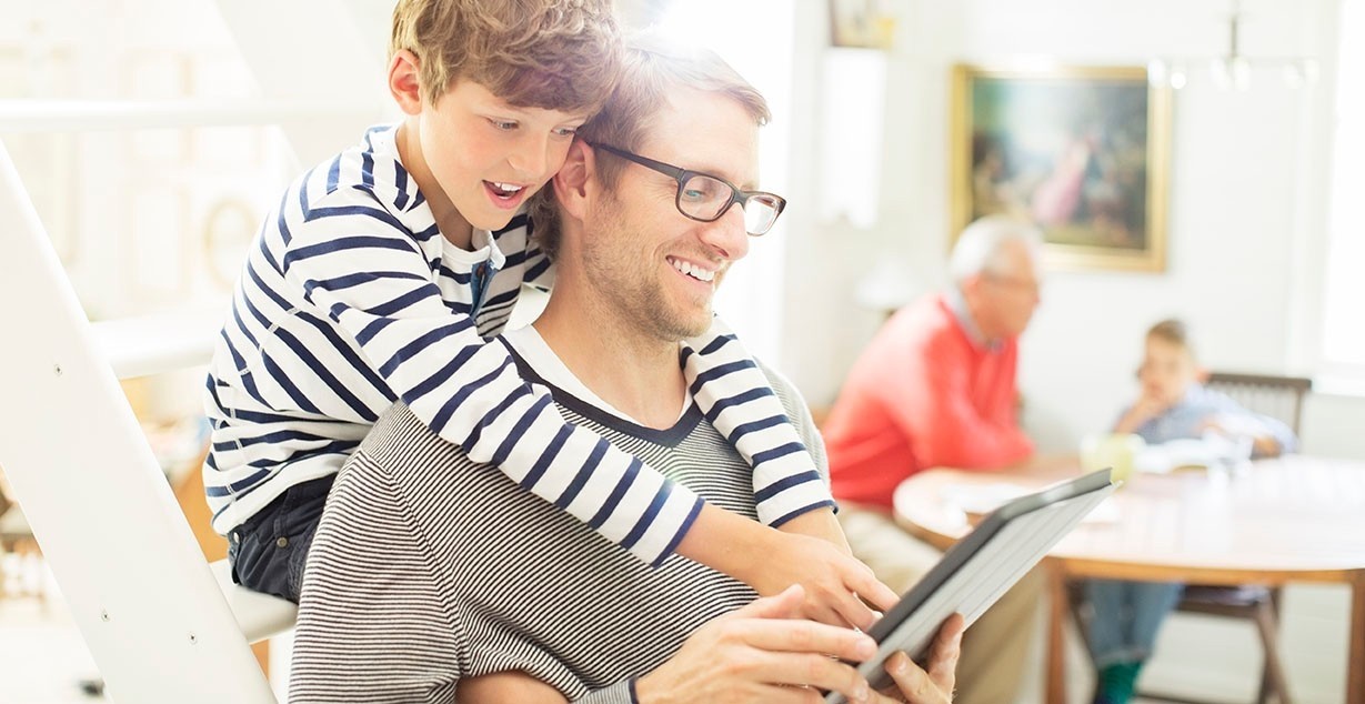 Father and son looking at tablet 