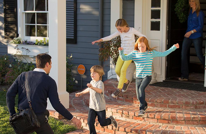 CHildren playing on front stoop of house 