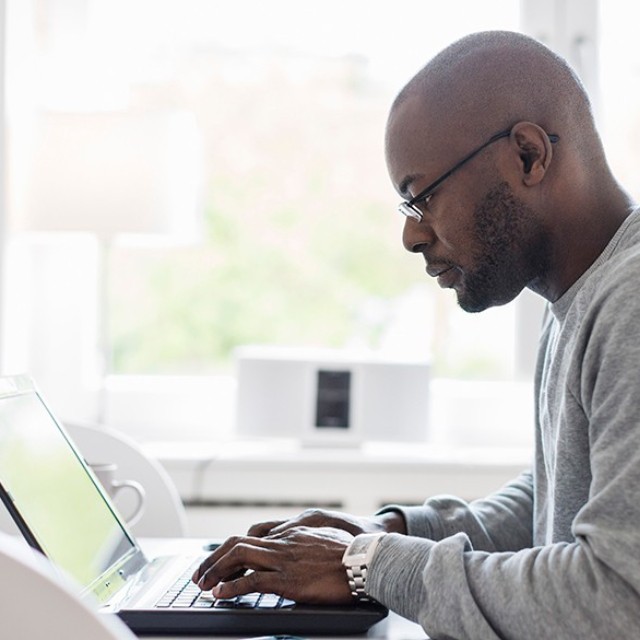 Man typing on a laptop 