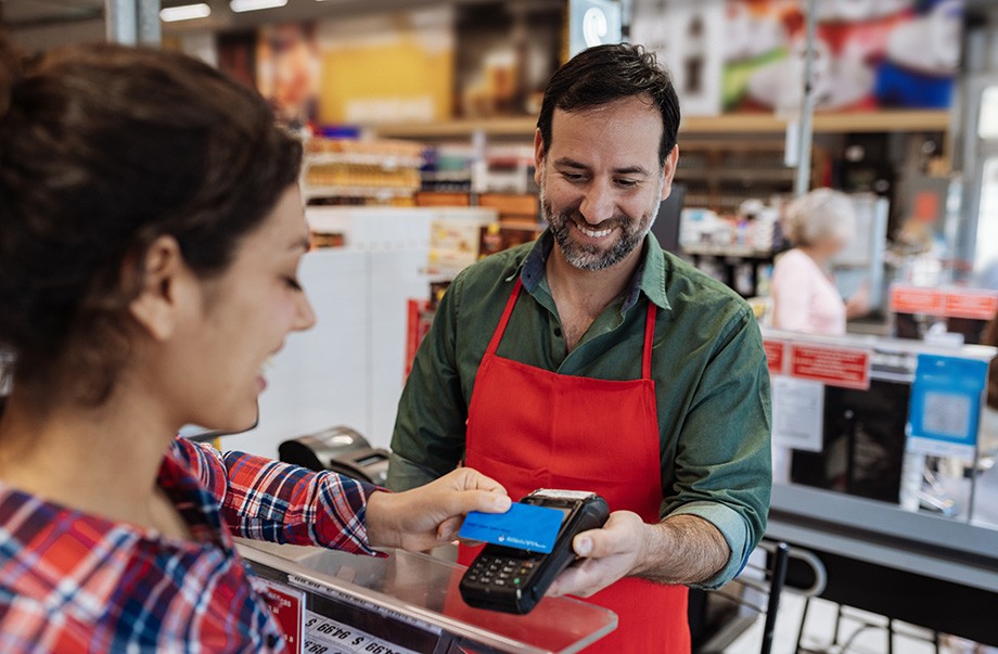 Shopping in modern supermarket and paying contactless