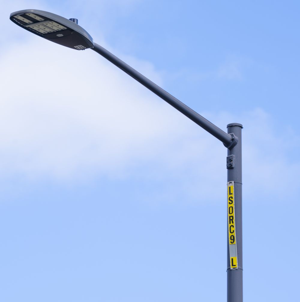 An image showing the pole numbers needed to report an outdoor lighting outage.